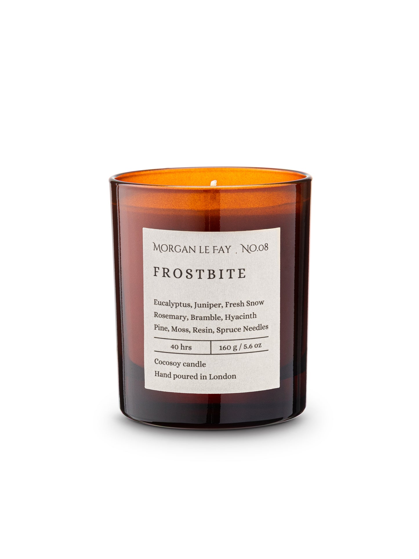 Candle with an orange glass container and white label on a white background