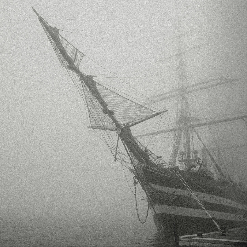 Black and white sailing ship at harbour