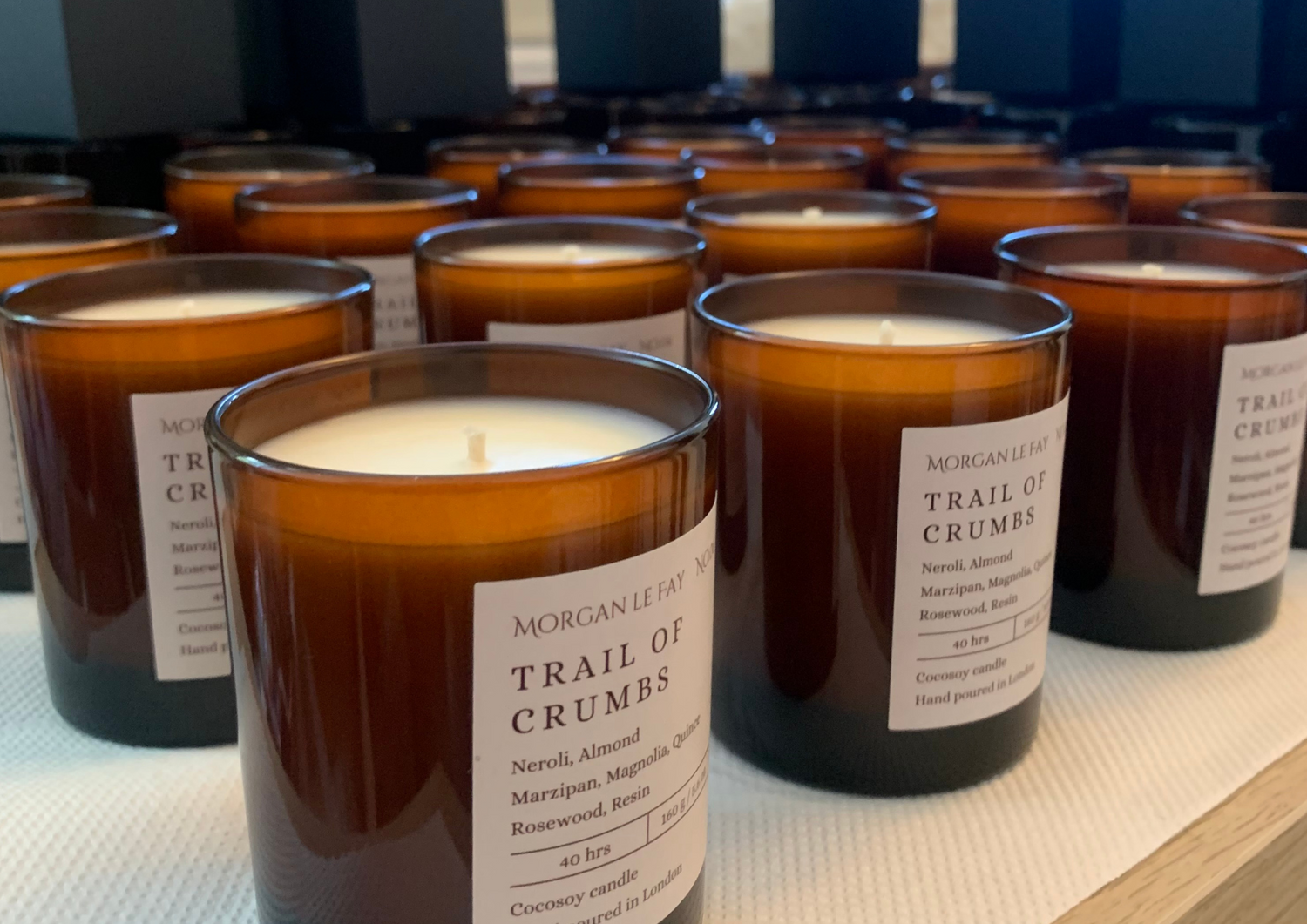 Rows of labelled candles in amber jars.