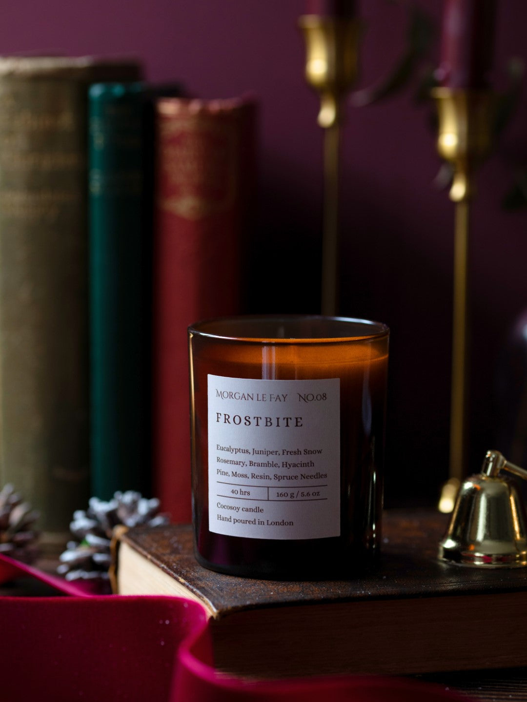 Frostbite candle with a label on a wooden surface against a dark background