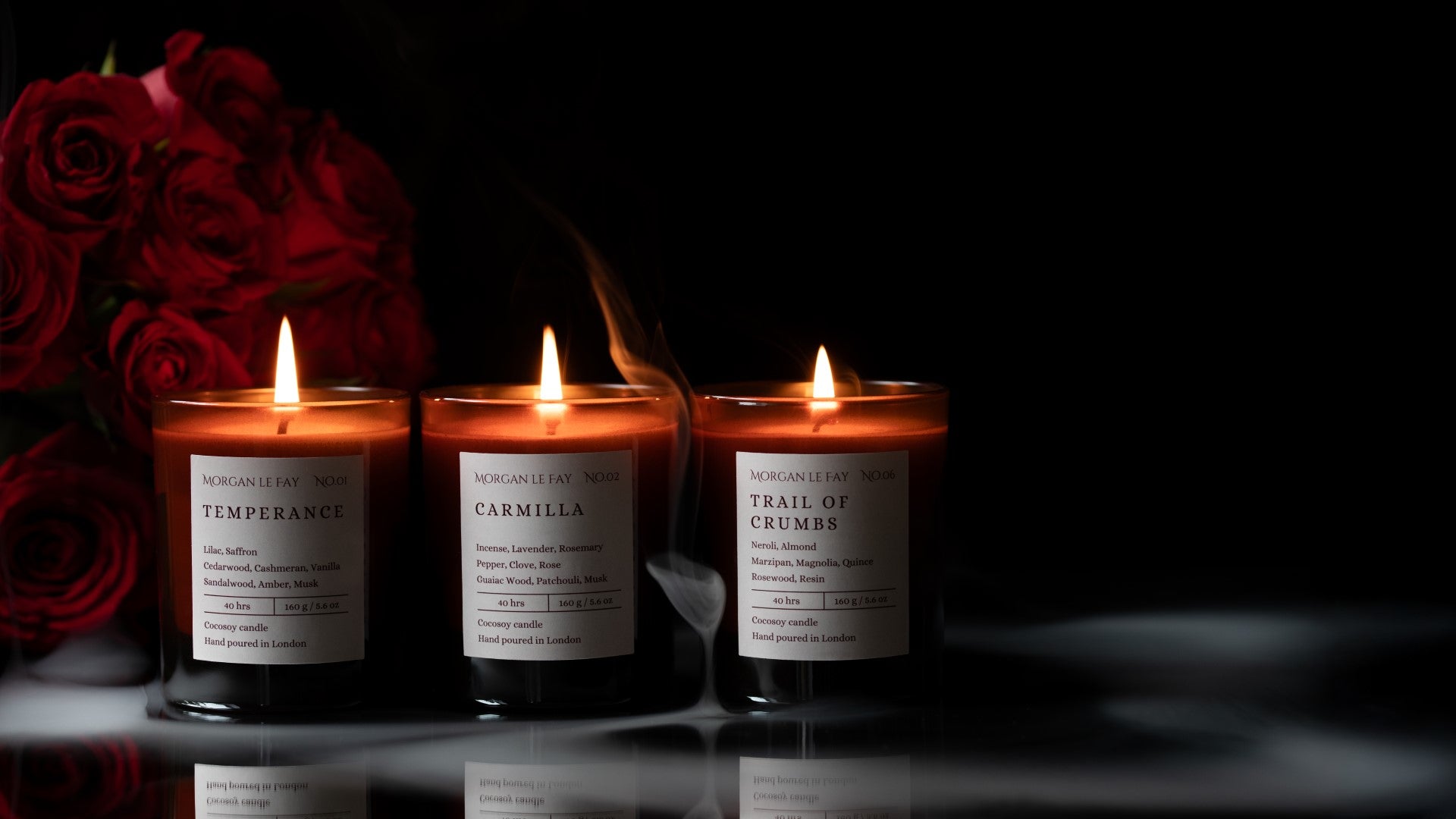 Three candles with labels on a dark background